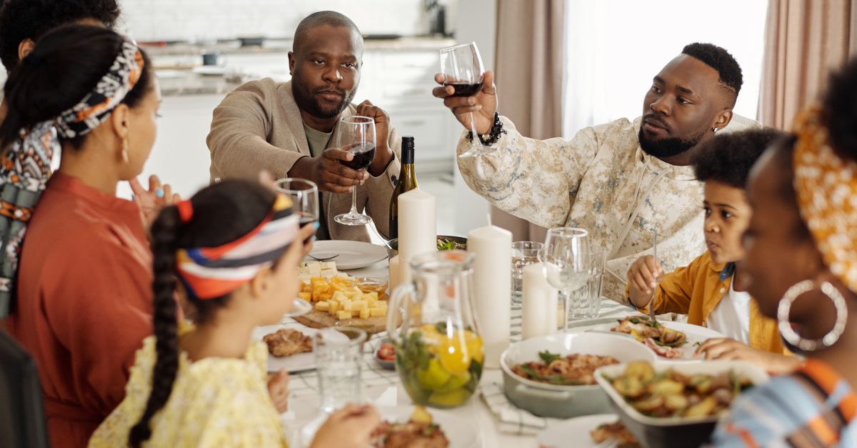 A joyful family dinner with wine toasts bringing together adults and children in a warm home setting.