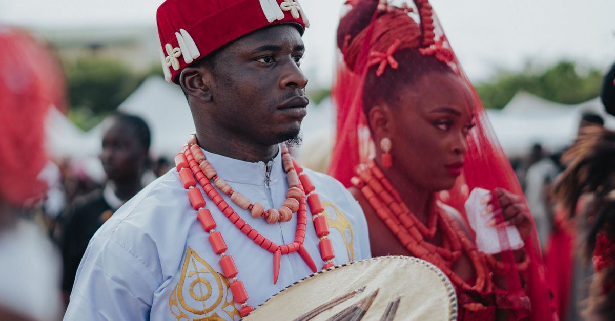 A captivating scene of Nigerian traditional wedding with vibrant attire and cultural drum.